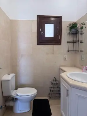 a bathroom with a toilet and a sink at The Charming Beachfront Retreat in Fanadir in Hurghada