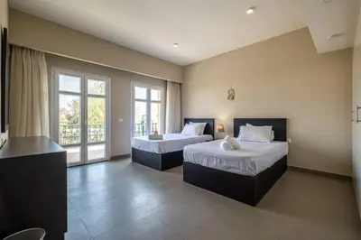 a bedroom with two beds and a large window at Ocean View: Spacious 2-Bed Apt in Hurghada