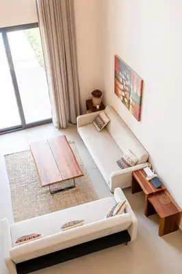 a living room with a couch and a table at Luxury 4BR + Nanny Villa • Ancient Sands in Hurghada