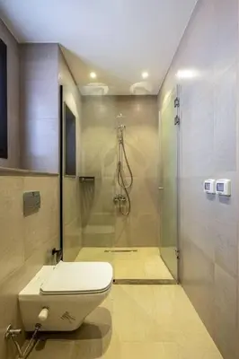 a bathroom with a toilet and a shower at Freshly Minted: 1BR Fanadir Marina in Hurghada