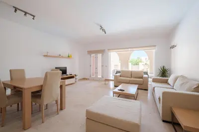 a living room with a couch and a table at 2BR New Marina Retreat • Private Pool in Hurghada