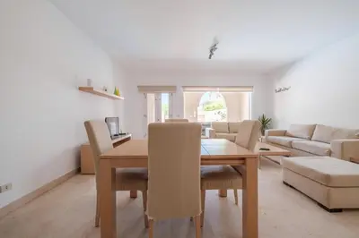 a dining room and living room with a table and chairs at 2BR New Marina Retreat • Private Pool in Hurghada