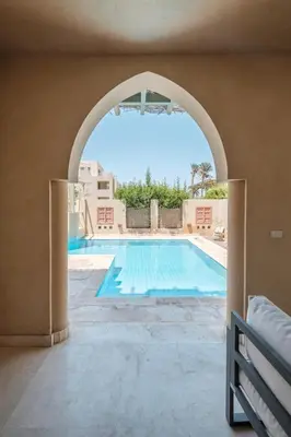 an archway leading to a swimming pool in a house at 2BR New Marina Retreat • Private Pool in Hurghada