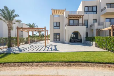 a villa with a pathway in front of a building at Shedwan 2 Bdr Ground Floor in Hurghada