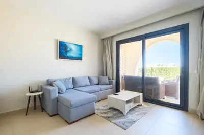 a living room with a couch and a table at Shedwan 2 Bdr Ground Floor in Hurghada