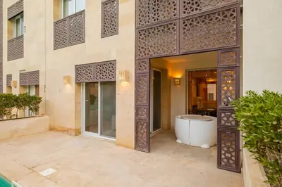 an entrance to a building with a tub in a courtyard at Stylish 1BR • Scarab Main Pool Access in Hurghada