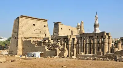 an ancient building with a tower in the background at Osiris Hotel Luxor \u60a8\u5728\u76e7\u514b\u7d22\u7684\u7b2c\u4e8c\u500b\u5bb6 in Luxor