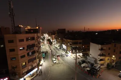 a city street at night with cars and buildings at Grand Memphis Hotel in Luxor in Luxor