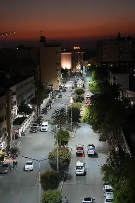 a city street with cars parked in a parking lot at Grand Memphis Hotel in Luxor in Luxor