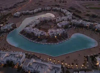 an aerial view of a resort with a swimming pool at Modern chalet at el gouna Swan Lake compound with Swimable lagoon view in Hurghada