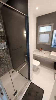 a bathroom with a shower and a toilet at Modern chalet at el gouna Swan Lake compound with Swimable lagoon view in Hurghada