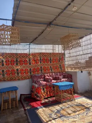 a room with a couch and a table in a tent at Grand Square Hostel Luxor in Luxor