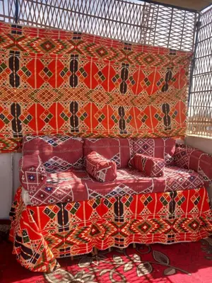 a room with a bed with red pillows at Grand Square Hostel Luxor in Luxor