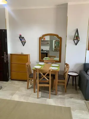 a dining room with a table and chairs and a mirror at Quiet quarter and private beach in Hurghada