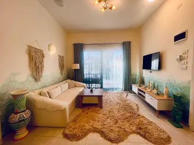 a living room with a couch and a tv at Amenti House - Private Villa & Retreat Center in Luxor