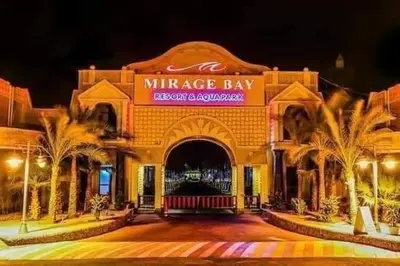 a large building with palm trees in front of it at ميراج باي in Hurghada