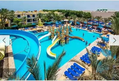 a large swimming pool with a water park at ميراج باي in Hurghada