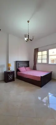 a bedroom with a large bed with a pink sheets at Luxury Two Bedrom Apartment in Hurghada