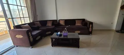 a living room with a couch and a coffee table at Luxury Two Bedrom Apartment in Hurghada