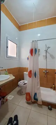 a bathroom with a shower curtain and a toilet at Luxury Two Bedrom Apartment in Hurghada