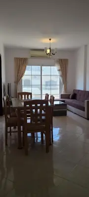 a dining room and living room with a table and chairs at Hurghada Al Hilal District in Hurghada