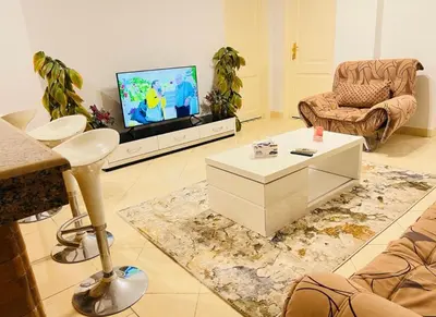 a living room with a couch and a tv at Sheraton St in Hurghada
