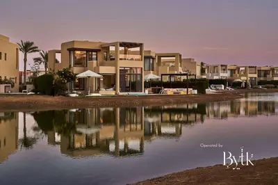 a house with its reflection in a body of water at BYTK - Villa La Calma in Hurghada