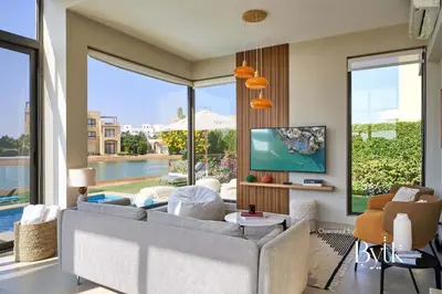 a living room with a couch and a tv at BYTK - Villa La Calma in Hurghada