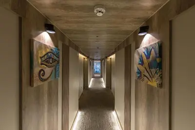a hallway with paintings on the walls of a building at Five Stars Nile Cruise from Luxor to Aswan 4 nights in Aswan