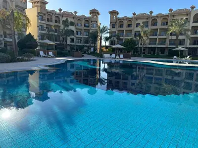 a large swimming pool in front of a building at Luxury Chalet in Alsaraya, Overlooking All of Sahl Hasheesh with Stunning Pool & Red Sea Views in Hurghada