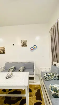 a living room with a white table and a couch at Star - private apartments in Luxor
