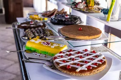 a buffet of cakes and other desserts on a table at Abu Dabbab Lodge in Abu Dabab