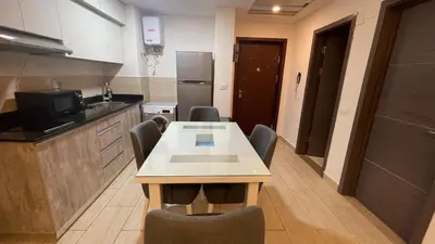a kitchen with a table and chairs in a room at Dani Apartment at Aldau Heights in Hurghada