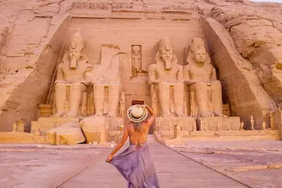 a woman is standing in front of anaraoh at Nile Cruise 3 nights From Aswan to Luxor in Aswan