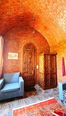 a living room with a couch and a brick wall at Luxor Tower in Luxor