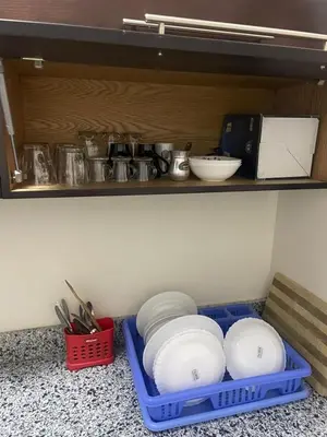 a shelf with bowls and utensils in a kitchen at The view in Hurghada