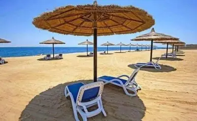a group of chairs and umbrellas on a beach at The view in Hurghada