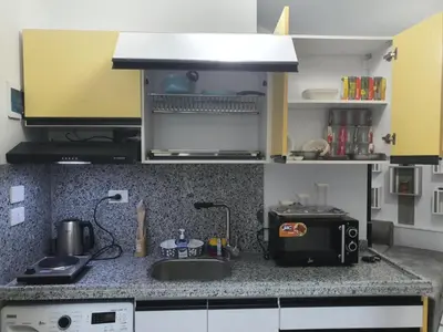 a kitchen counter with a sink and a microwave at Juliana Beach Resort AG01 in Hurghada