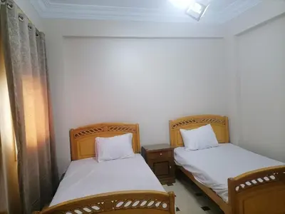 two beds in a small room withermottermottermott at villa on Nile in Luxor