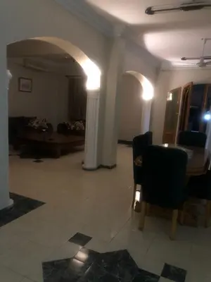 a living room with a table and a couch at villa on Nile in Luxor