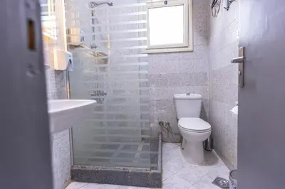 a bathroom with a toilet and a sink and a shower at Lazur Pool Apartment's - El Kawsar, Hurghada - Egypt in Hurghada