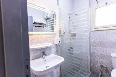 a bathroom with a sink and a glass shower at Lazur Pool Apartment's - El Kawsar, Hurghada - Egypt in Hurghada