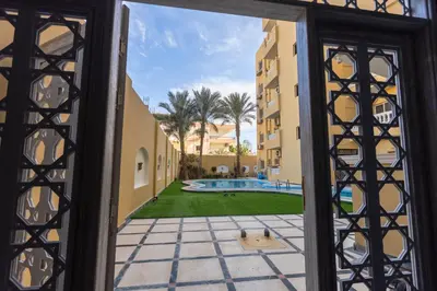 a view of the pool from the door of a building at Lazur Pool Apartment's - El Kawsar, Hurghada - Egypt in Hurghada