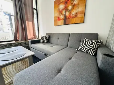 a living room with a couch and a table at Falcon Loft Studio Sheraton Road in Hurghada