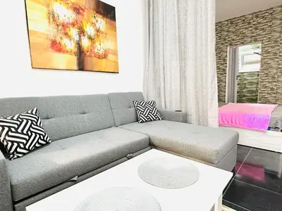 a living room with a couch and a table at Falcon Loft Studio Sheraton Road in Hurghada