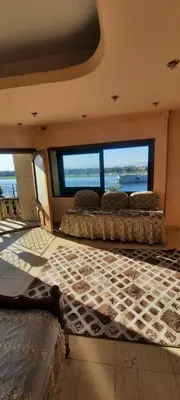 two beds in a room with a view of the ocean at The Best View With Great Location 2 Bedroom Apartment in Luxor in Luxor