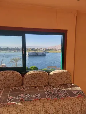 a large window with a view of a body of water at The Best View With Great Location 2 Bedroom Apartment in Luxor in Luxor