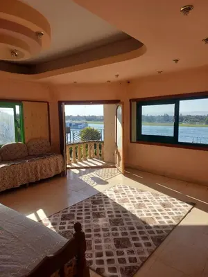 a bedroom with a bed and a view of the water at The Best View With Great Location 2 Bedroom Apartment in Luxor in Luxor