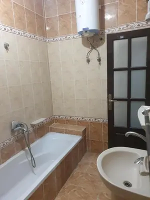 a bathroom with a tub and a sink at El Quarn Apartment in ‘Ezbet Abu Ḥabashi