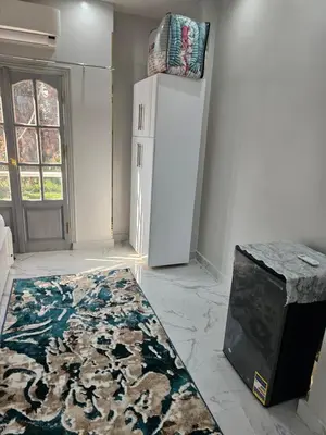 a kitchen with a refrigerator and a rug on the floor at King Mina Nubian House in Aswan